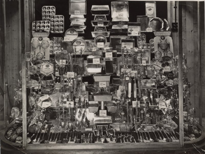A window of products all made of tin, from Woolworths in the 1930s. Click for a larger copy in a new window.